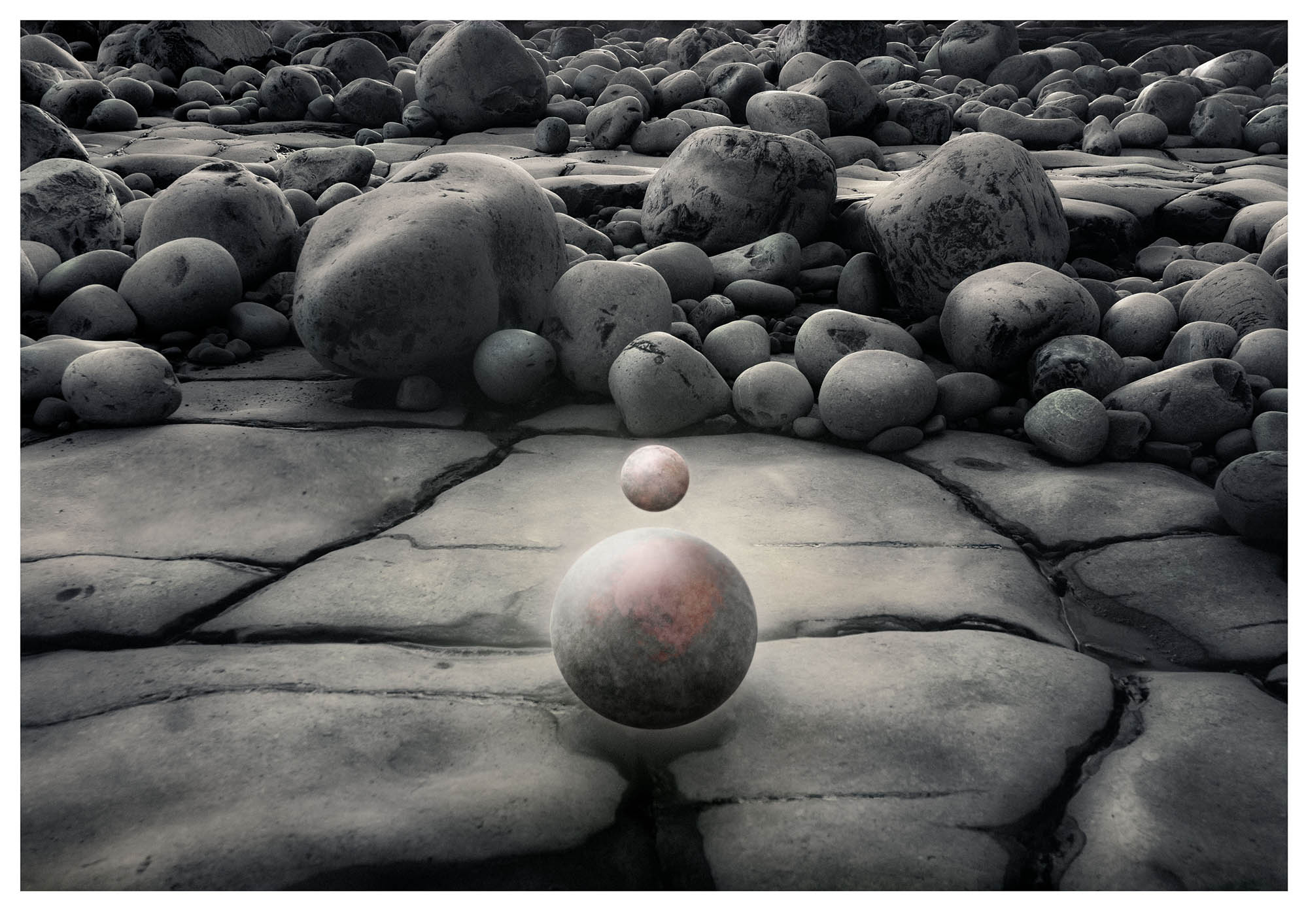 Jurassic boulders form background for small planet floating above larger one in surreal fantadsy universe photograph